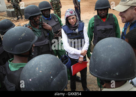 SOMALIA, Baidoa: In a photograph taken and released by the African Union-United Nations Information Support Team 20 October 2013, Joanna Reid (centre), head of UK Department of Foreign and International Development (DFID) in Somalia listens during a meeting meet with a team of Somali mine and ordinance disposal experts deployed to defuse bombs and other improvised explosives devices (IEDs) planted in and around the town by suspected Al-Shabaab militants. Reid was visiting the capital of Somalia's Bay and Bakool Region to see first-hand the impact and progress of UK-funded projects to renovate  Stock Photo