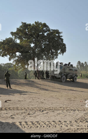 Ugandan soldiers, belonging to the African Union Mission in Somalia, stand outside one of their armored vehicles in the town of Janaale, Somalia, on March 21 ahead of an offensive currently being planned on the nearby town of Qoryooley. AU UN IST PHOTO / Tobin Jones Stock Photo