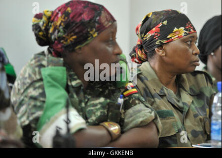 AMISOM UPDF Female soldiers listening to AMISOM's new Woman & Child Protection Office, Kaoutar Kaddouri, deliver her speech during a meeting for Female peacekeepers held on 1st July 2014 in Mogadishu, Somalia. AMISOM Photo / David Mutua Stock Photo