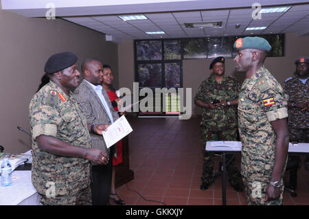 Maj. Kakurungu from UPDF prepares to receive a certificate from the UPDF Chief of Defence Forces, Gen Katumba Wamala.jpg Stock Photo