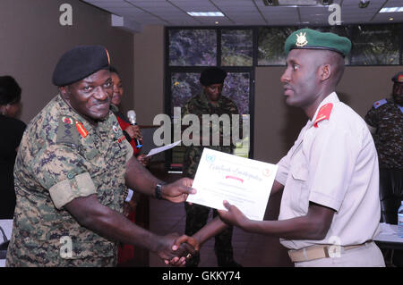 Chief Inspector Rodgers Gathuru from Kenya Police Service receives a certificate from the UPDF Chief of Defence Forces Gen Katumba Wamala.jpg Stock Photo