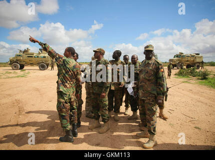 SOMALIA, Afgoye: In a photograph dated 26 May and released by the African Union-United Nations Information Support Team 27 May, Colonel Kayanja Muhanga, commander of the African Union Mission in Somalia (AMISOM) Battle Group 8, discusses with counterparts from the Somali National Army (SNA) and other AMISOM filed commanders south of the town of Afgoye to the west of the Somali capital Mogadishu. An joint-AMISOM and Somali National Army (SNA) offensive has driven the Al-Qaeda-affiliated extremist group Al Shabaab from the strategically important area of the Afgoye corridor, which the group used Stock Photo