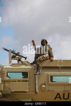 SOMALIA, Afgoye: In a photograph dated 26 May and released by the African Union-United Nations Information Support Team 27 May, a Ugandan gunner serving with the African Union Mission in Somalia (AMISOM) is seen sitting atop an armoured personnel carrier at a location south of the town of Afgoye, west of the Somali capital Mogadishu in preparation to deploy south of the town on the road to Merka. An joint-AMISOM and Somali National Army (SNA) offensive has driven the Al-Qaeda-affiliated extremist group Al Shabaab from the strategically important area of the Afgoye corridor, which the group use Stock Photo
