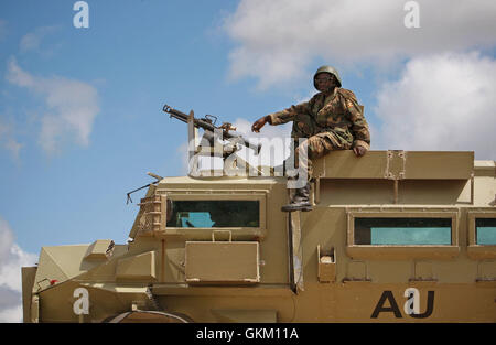 SOMALIA, Afgoye: In a photograph dated 26 May and released by the African Union-United Nations Information Support Team 27 May, a Ugandan gunner serving with the African Union Mission in Somalia (AMISOM) is seen sitting atop an armoured personnel carrier at a location south of the town of Afgoye, west of the Somali capital Mogadishu in preparation to deploy south of the town on the road to Merka. An joint-AMISOM and Somali National Army (SNA) offensive has driven the Al-Qaeda-affiliated extremist group Al Shabaab from the strategically important area of the Afgoye corridor, which the group use Stock Photo
