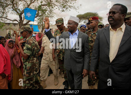 SOMALIA, Balad: In a photograph taken 01 August and released by the African Union-United Nations Information Support team 02 August, Somali President Sheik Sharif Sheik Ahmed greets residents of Balad town in Middle Shabelle region approx. 40km north east of the capital Mogadishu. Balad was until recently, under the control of the Al-Qaeda-affliated terrorist group Al Shabaab until an offensive by the Somali National Army (SNA) supported by the African Union Mission in Somalia (AMISOM) forces on 26 June drove out the extremists, liberating the town and its people, and bringing the area under t Stock Photo