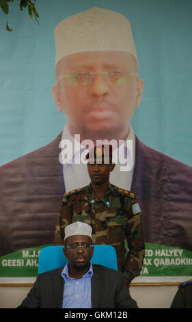 SOMALIA, Balad: In a photograph taken 01 August and released by the African Union-United Nations Information Support team 02 August, Somali President Sheik Sharif Sheik Ahmed sits in front of a portrait of himself during a meeting with traditional elders and leaders of Balad town in Middle Shabelle region approx. 40km north east of the capital Mogadishu. Balad was until recently, under the control of the Al-Qaeda-affliated terrorist group Al Shabaab until an offensive by the Somali National Army (SNA) supported by the African Union Mission in Somalia (AMISOM) forces on 26 June drove out the ex Stock Photo