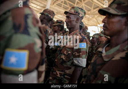 SOMALIA, Mogadishu: In a photograph released by the African Union-United Nations Information Support team 14 August, recently trained members of the Somali National Army (SNA) stand during a passing-out parade at an African Union Mission in Somalia (AMISOM) training facility on the western fringes of the Somali capital Mogadishu. 660 Somali soldiers who had recently returned from 8 months training in Bihanga, Uganda, passed out along with 48 elite commandos, following a display of tactical and security exercises which included demonstrations of house-clearing, manning of vehicle checkpoints an Stock Photo