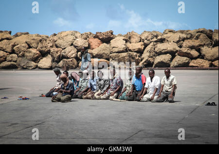 SOMALIA, Kismayo: In a photograph taken 15 July 2013 and released by the African Union-United Nations Information Support Team 22 July, workers at Kismayo Seaport in southern Somalia pray during the holy month of Ramadan. AU-UN IST PHOTO / RAMADAN MOHAMED HASSAN.
