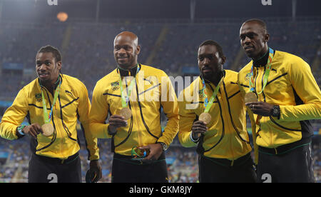 (From left to right) Jamaica's Yohan Blake, Asafa Powell, Nickel Ashmeade and Usain Bolt with their gold medals after victory in the the Men's 4 x 100m relay final at the Olympic Stadium on the fifteenth day of the Rio Olympic Games, Brazil. Stock Photo