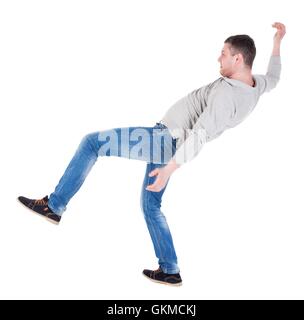 Back view man Balances waving his arms. Stock Photo