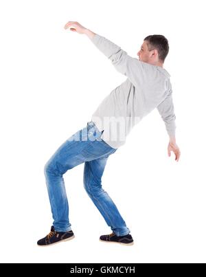 Back view man Balances waving his arms. Stock Photo