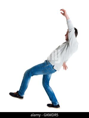 Back view man Balances waving his arms. Stock Photo