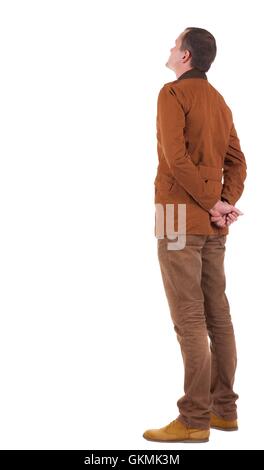 Back view of stylishly dressed man in a brown jackett looking up. Standing young guy in jeans and jacket. Rear view people collection. backside view of person. Isolated over white background. Stock Photo