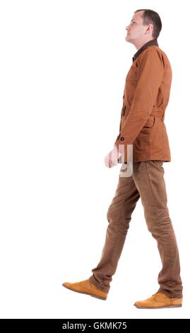 Back view of going  stylishly dressed man in a brown jacket.  walking young guy. Rear view people collection.  backside view of Stock Photo