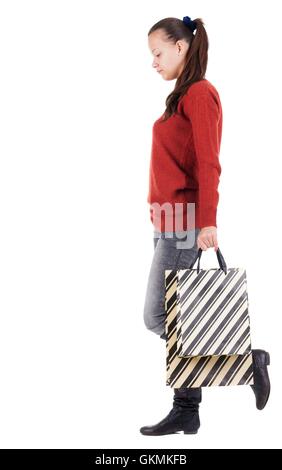 back view of going woman with shopping bags . beautiful brunette girl in motion. backside view of person. Rear view people collection. Isolated over white background. Stock Photo