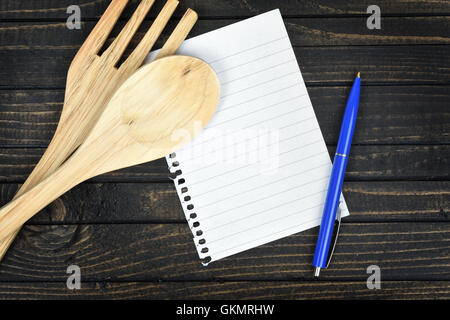Kitchen utensils and empty page on wooden table Stock Photo