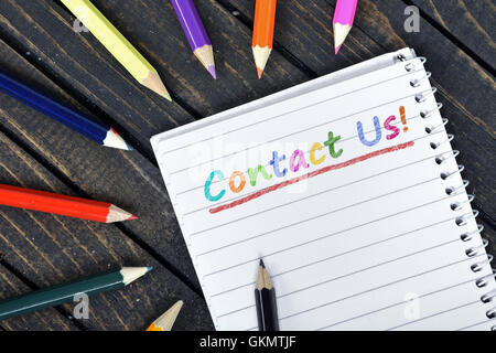 Contacts us text on notepad and colorful pencils Stock Photo
