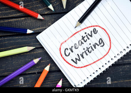 Creative Writing text on notepad and colorful pencils Stock Photo