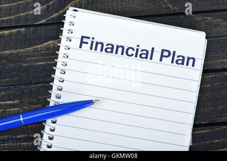 Financial Plan text on notepad and blue pen Stock Photo