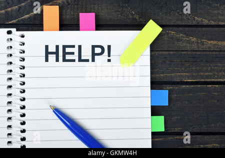 Help word on notepad and pen Stock Photo