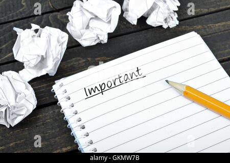 Important text on notepad and crippled paper Stock Photo
