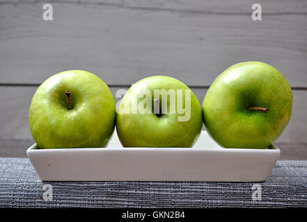 three apples on plate Stock Photo