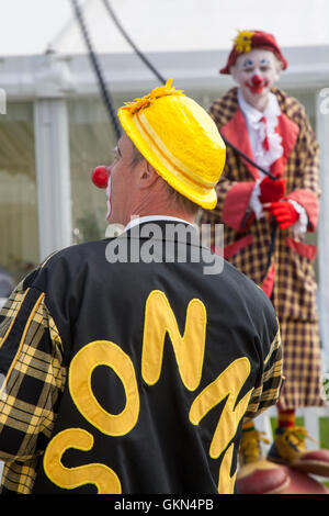 Sonny & Rainbow  entertain the crowds by skipping and walking on a ball.  As two of the funniest clowns around, Gordon Murray  and Gary McBeth, can turn everyday situations into funny scenarios.  The crowds were blown away by their antics as the duo performed in front of a record final day attendance at the showground arena at the 48th annual Southport Flower Show. Stock Photo