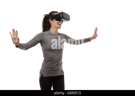 virtual reality fitness woman looking at the world before her eyes Stock Photo