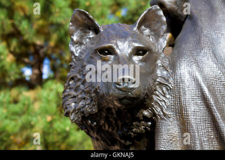 SANTA FE, NEW MEXICO, USA, OCTOBER 17, 2105: Bronze wolf statue at side of of Saint Francis of Assisi sculpture in Santa Fe Stock Photo