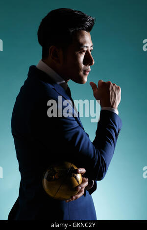 Young business man holding the globe Stock Photo