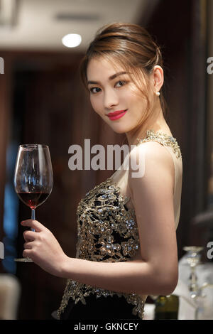 A beautiful young woman holding goblet Stock Photo