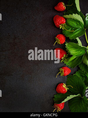 top view of delicious strawberries and ripe sweet cherries in bowls on ...