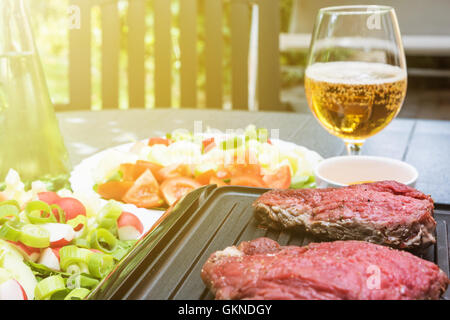 Grill steak on an electric stove. Pork neck fried on small electric grill.  Home cooking. Healthy barbecue. Catering to friends. Electric grilling.  Stock Photo