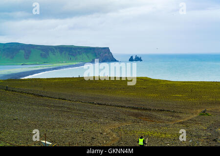 View of Famous Reynisdrangar rock formations from the cape Dyrholaey near the village of Vik in Iceland Stock Photo