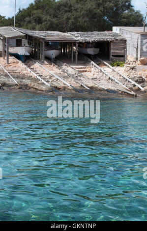 Formentera, Balearic Islands: the wooden walkways to pull up the boats at Es Calo, a small fishing village Stock Photo