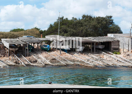 Formentera, Balearic Islands: the wooden walkways to pull up the boats at Es Calo, a small fishing village Stock Photo