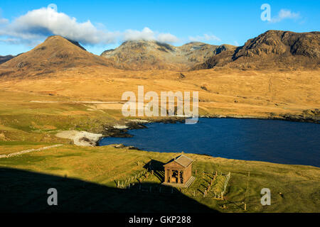 The Bullough Mausoleum and the Rum Cuillin hills from Harris Bay, Isle of Rum, Scotland, UK. Stock Photo