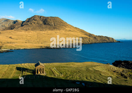 The Bullough Mausoleum and Ruinsival in the Rum Cuillin hills from Harris Bay, Isle of Rum, Scotland, UK. Stock Photo