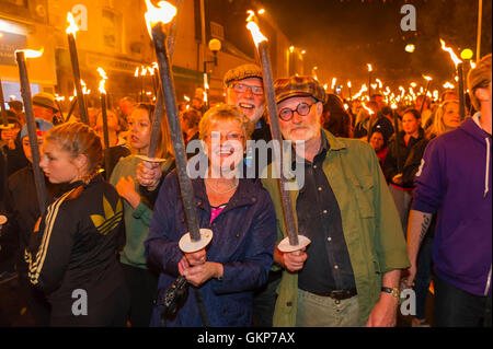 Bridport, Dorset, UK. 21st Aug, 2016. About 2,000 people with flaming torches take part in the annual Bridport Carnival Torchlight Parade which leaves from Bucky Doo Square at Bridport Town Hall and goes to the beach at West Bay over a route of one and a half miles. Picture Credit:  Graham Hunt/Alamy Live News Stock Photo