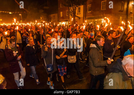 Bridport, Dorset, UK. 21st Aug, 2016. About 2,000 people with flaming torches take part in the annual Bridport Carnival Torchlight Parade which leaves from Bucky Doo Square at Bridport Town Hall and goes to the beach at West Bay over a route of one and a half miles. Picture Credit:  Graham Hunt/Alamy Live News Stock Photo