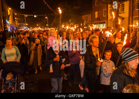 Bridport, Dorset, UK. 21st Aug, 2016. About 2,000 people with flaming torches take part in the annual Bridport Carnival Torchlight Parade which leaves from Bucky Doo Square at Bridport Town Hall and goes to the beach at West Bay over a route of one and a half miles. Picture Credit:  Graham Hunt/Alamy Live News Stock Photo