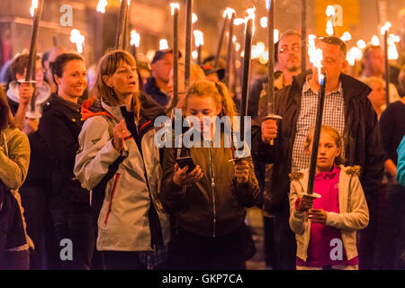 Bridport, Dorset, UK. 21st Aug, 2016. About 2,000 people with flaming torches take part in the annual Bridport Carnival Torchlight Parade which leaves from Bucky Doo Square at Bridport Town Hall and goes to the beach at West Bay over a route of one and a half miles. Picture Credit:  Graham Hunt/Alamy Live News Stock Photo