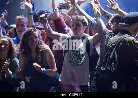 Brecon, Wales, UK, August 21 2016. The final day of the Green Man Festival 2016 at the Glanusk Estate in Brecon, Wales. Pictured: Belle & Sebastian bring the festival to a close by headlining the Mountain Stage during heavy rainstorms. As is their tradition the band invited audience members to come on stage and dance at the end of the set and it got a bit out-of-hand as dozens rushed the stage finally obscuring the band. Picture: Rob Watkins/Alamy Live News Stock Photo