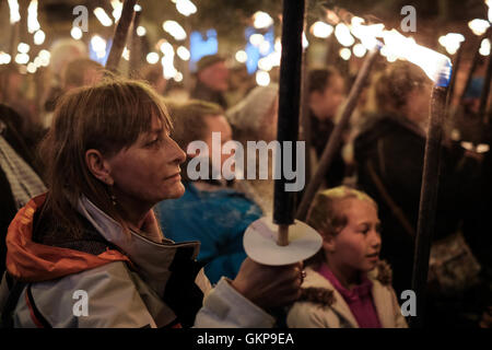 Bridport Torchlight Procession, Bridport, Dorset, UK. 21st Aug, 2016. Thousands of blazing torches were carried from Bridport's Bucky Doo Square to West Bay's East Cliff where music, fireworks and a giant bonfire helped celebrate the end of Bridport's Carnival week. The Bridport Carnival first started in 1911, was abandoned in 1920 then resurrected in 1971 and has been a popular annual event for locals and visitors since. Credit:  Tom Corban/Alamy Live News Stock Photo