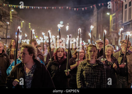 Bridport Torchlight Procession, Bridport, Dorset, UK. 21st Aug, 2016. Thousands of blazing torches were carried from Bridport's Bucky Doo Square to West Bay's East Cliff where music, fireworks and a giant bonfire helped celebrate the end of Bridport's Carnival week. The Bridport Carnival first started in 1911, was abandoned in 1920 then resurrected in 1971 and has been a popular annual event for locals and visitors since. Credit:  Tom Corban/Alamy Live News Stock Photo