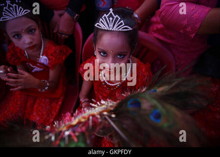 August 23, 2016 - Lalitpur, Nepal - A Nepalese girl whom are considered holy looks on while taking part in a procession to celebrate the festival of Deity Narsingh in Patan, Lalitpur, Nepal on Tuesday, August 23, 2016. Nepalese people from all over Patan of Newar community gather to offer worship by placing flowers and money to divinities as a belief to receive blessings and wellbeing of ones family. The ritual dates back to some 400 years. (Credit Image: © Skanda Gautam via ZUMA Wire) Stock Photo