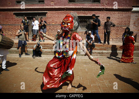 Lalitpur, Nepal. 23rd Aug, 2016. A Nepalese person dressed as a Lakhey performs a traditional dance during the deity procession to celebrate the festival of Narsingh in Patan Durbar Square, Lalitpur, Nepal on Tuesday, August 23, 2016. Nepalese people from all over Patan of Newar community gather to offer worship by placing flowers and money to divinities as a belief to receive blessings and wellbeing of ones family. The ritual dates back to some 400 years. © Skanda Gautam/ZUMA Wire/Alamy Live News Stock Photo