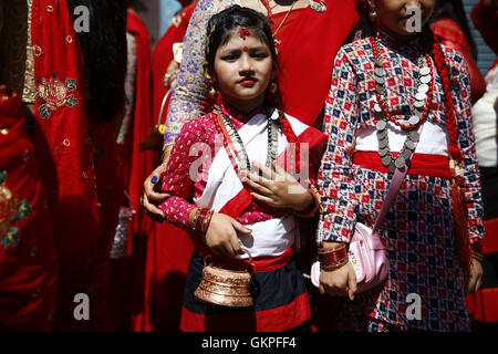 Lalitpur, Nepal. 23rd Aug, 2016. A Nepalese girl dressed in traditional Newari costume looks on as she takes part in a procession to worship Deity Ganesh to receive blessings and wellbeing of ones family in Patan, Lalitpur, Nepal on Tuesday, August 23, 2016. © Skanda Gautam/ZUMA Wire/Alamy Live News Stock Photo