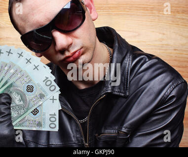 Mafia gangster with a fan polish money Stock Photo