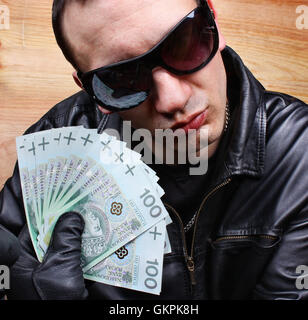 Mafia gangster with a fan polish money Stock Photo